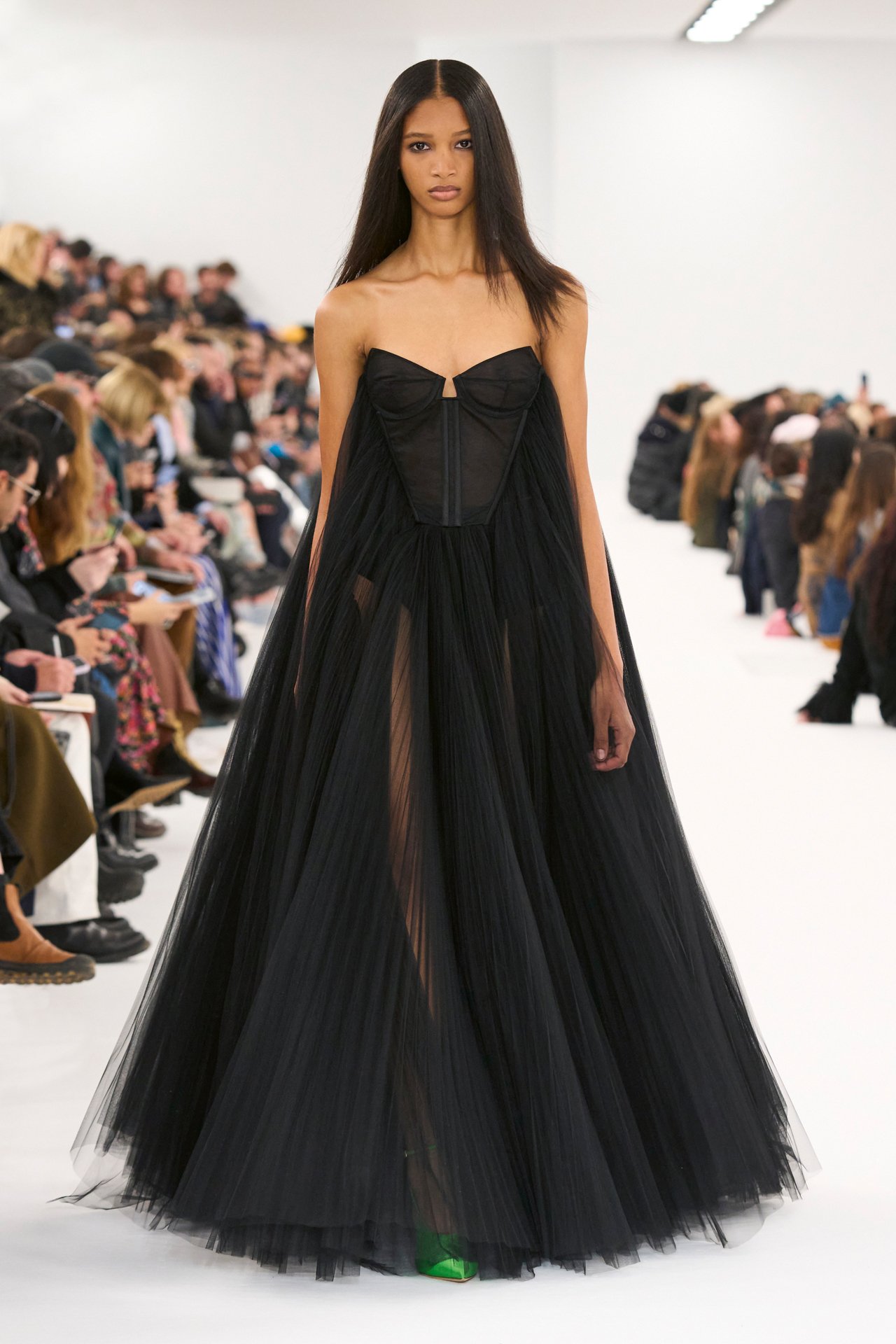 Givenchy's Haute Couture stands as a striking demonstration of the House's innovative design philosophy. The model's silhouette, designed by Matthew M. Williams, marked by sheer panels and a form-fitting bodice, makes a statement on the catwalk.