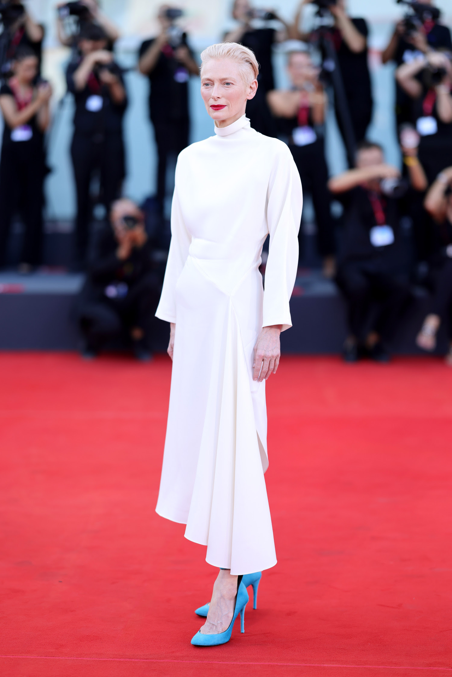 At the 81st Venice International Film Festival, Tilda Swinton graced the premiere of ‘Queer’ in an ivory asymmetric dress from Alaïa's Summer Fall 2024 collection, designed by Pieter Mulier. (Image courtesy of Getty Images and ALAÏA)