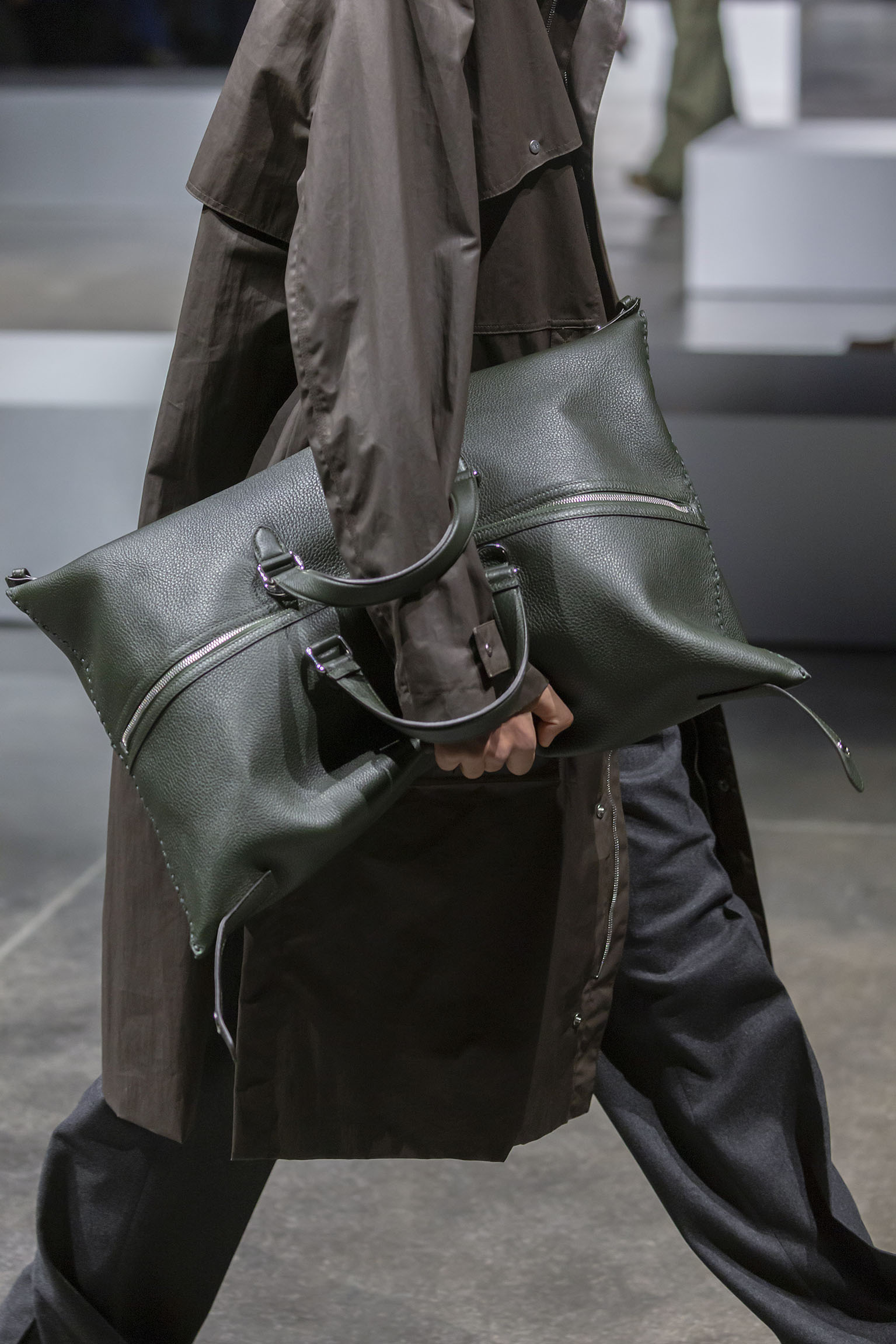 The FENDI Large Siesta bag Selleria version in dark green is seen with closures unfastened forming an unstructured pillow bag on the FENDI Fall/Winter 2024 runway.