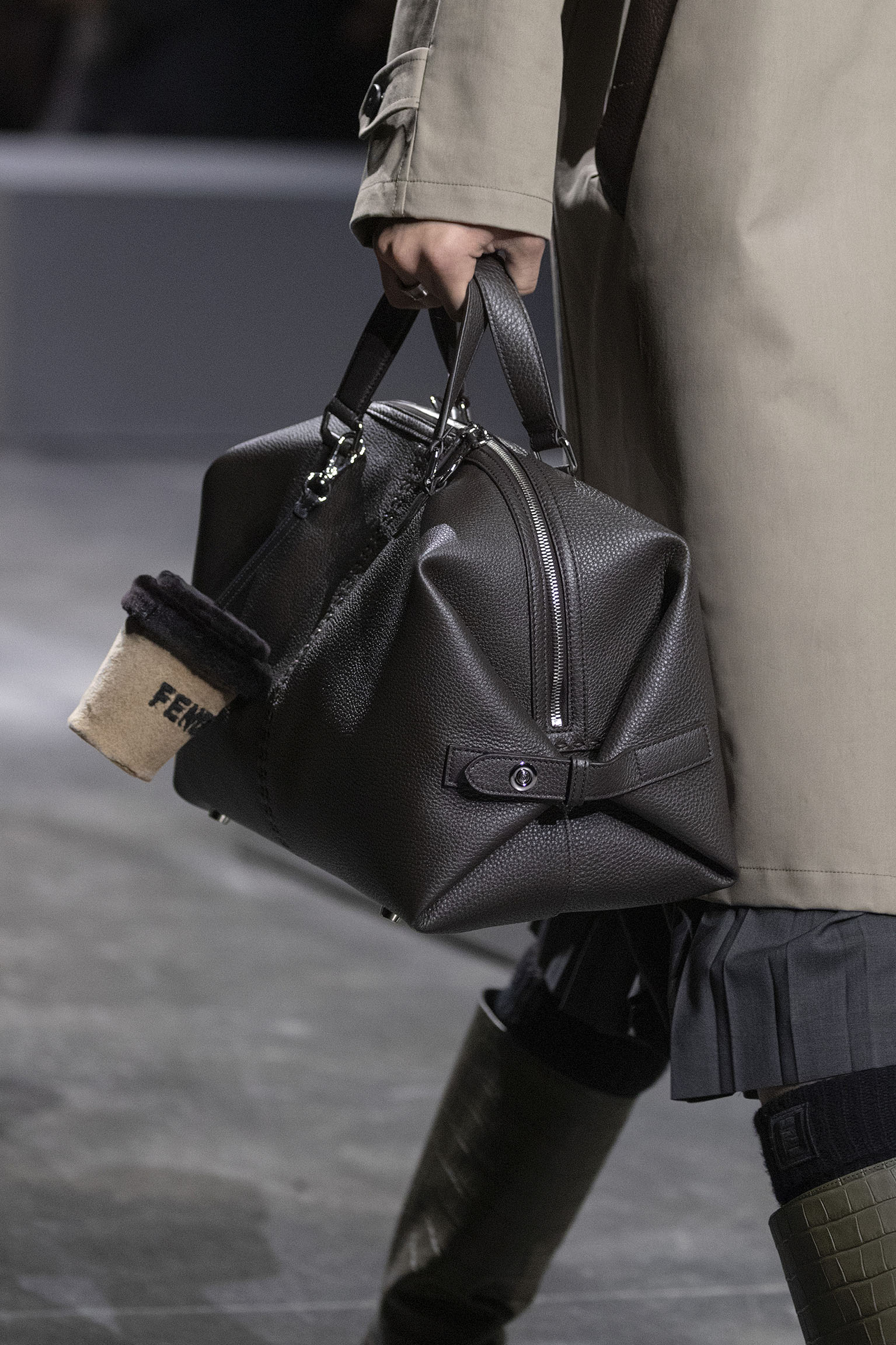 The FENDI Medium Siesta bag Selleria version in black is seen with fastened closures forming a structured duffle on the FENDI Fall/Winter 2024 runway.
