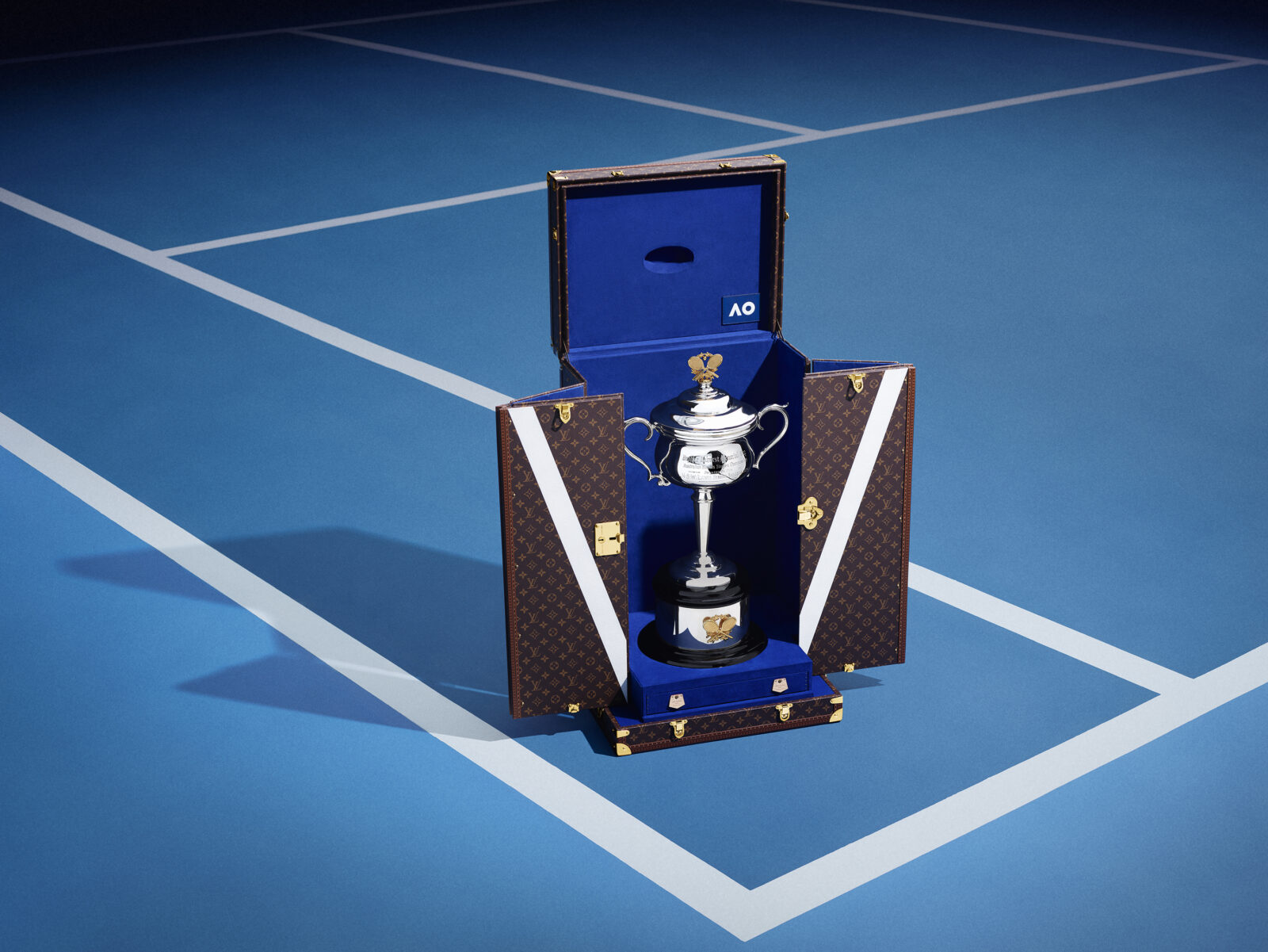 The Australian Open's gleaming trophies, encased in Louis Vuitton's iconic Monogram canvas trunks, ready for their grand reveal on the blue courts of Melbourne. Imagery, courtesy of Louis Vuitton.