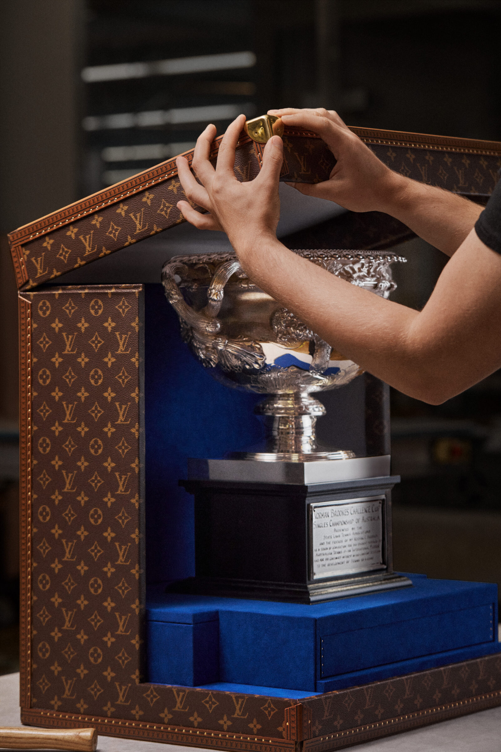 A close-up of the intricate finishing touches and details on the Official Trophy Trunks, embodying the spirit of the Australian Open and Louis Vuitton's legacy of excellence.