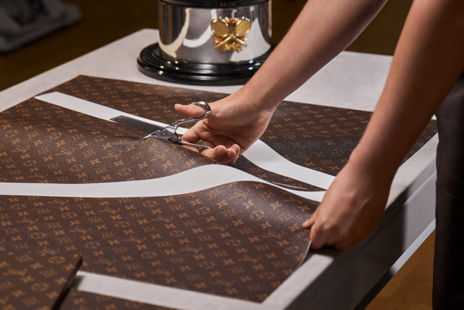 Artisans at Louis Vuitton's Asnières workshop meticulously craft the bespoke Trophy Trunks, weaving together tradition and modernity.