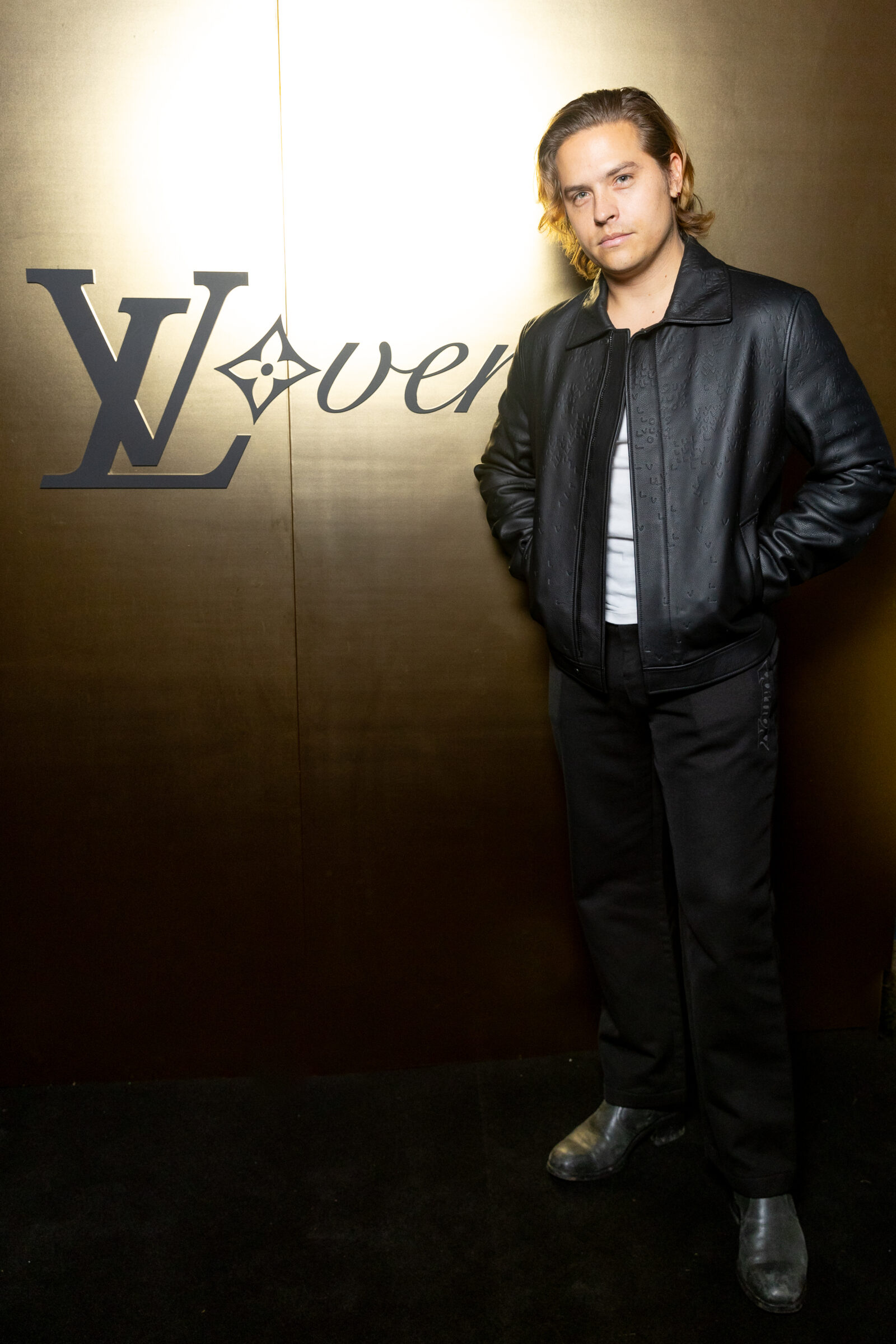 Dylan Sprouse, exuding modern elegance at the Louis Vuitton event, mirrors the opulent yet contemporary spirit of Pharrell’s SS24 collection.