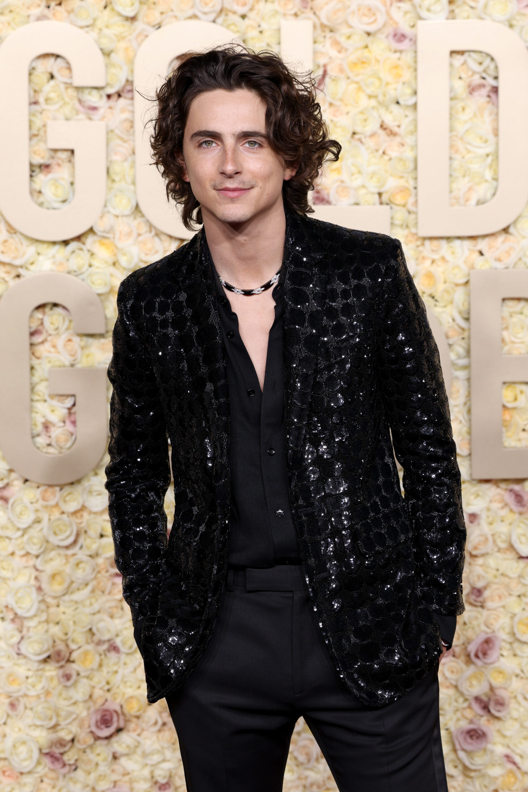 Timothée Chalamet exudes elegance at the Golden Globes in a sparkling black wool gabardine jacket by CELINE HOMME. (Photo by Kevin Mazur/Getty Images, courtesy of CELINE)