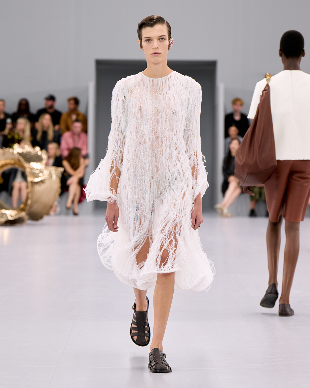 A LOEWE look captures the collection's playful chaos, paying homage to artful innovation and youthful verve.