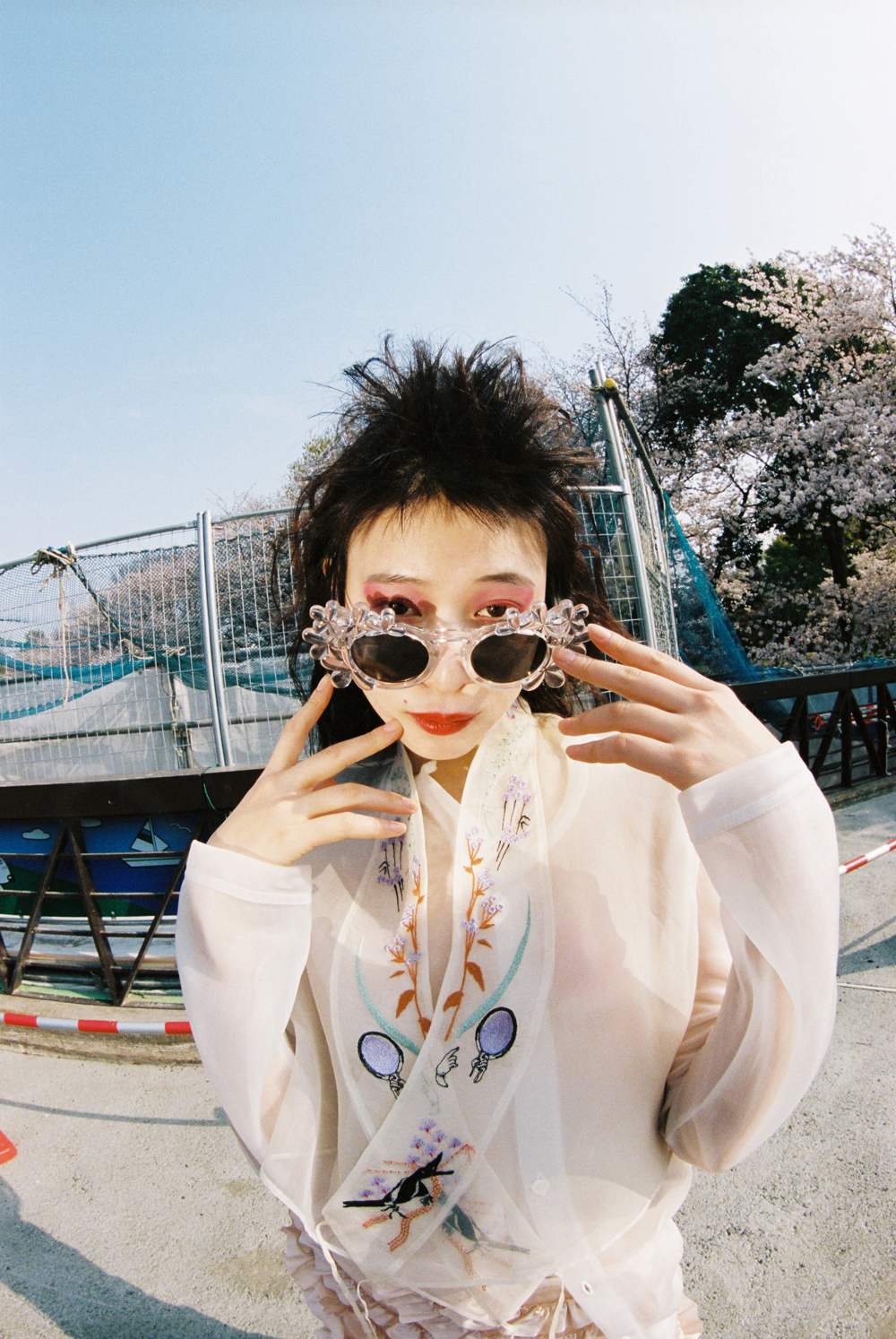 Top by JUNYA WATANABE COMME DES GARÇONS, top by MAME KUROGOUCHI, skirt and sunglasses by 4 MONCLER SIMONE ROCHA
