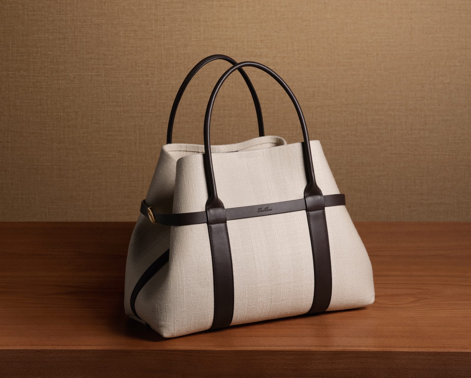 The canvas version features contrasting leather trim while the signature Sun Gold clasp detail illustrates the bag's second shape
