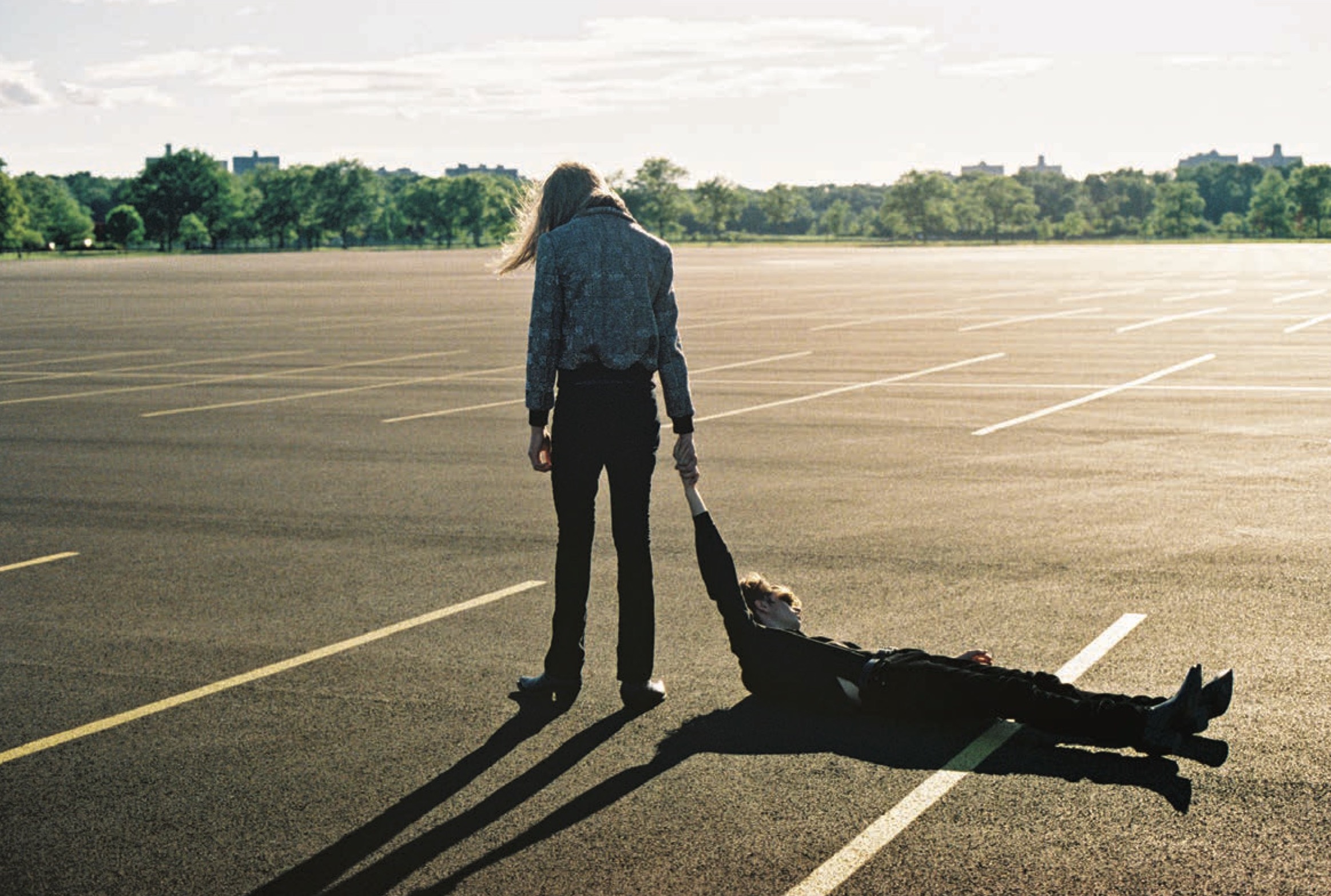 Aiden wears jacket, shirt, jeans, belt, and boots by SAINT LAURENT BY ANTHONY VACCARELLO. Miles wears shirt, jeans, belt, and boots by SAINT LAURENT BY ANTHONY VACCARELLO