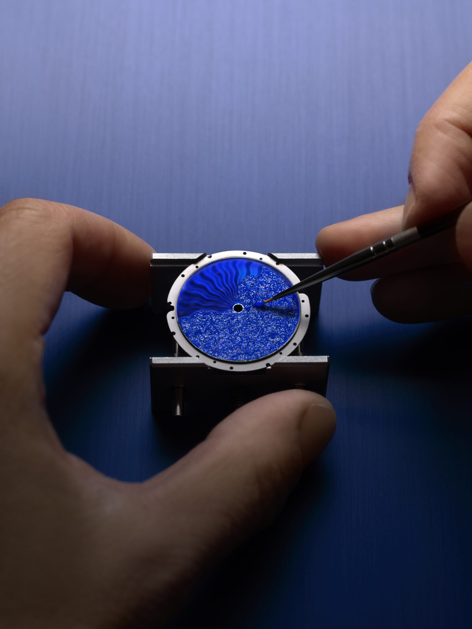 A master artisan applies finishing touches to the brilliant blue grand feu enamel dial. (Image: Courtesy of Louis Vuitton)