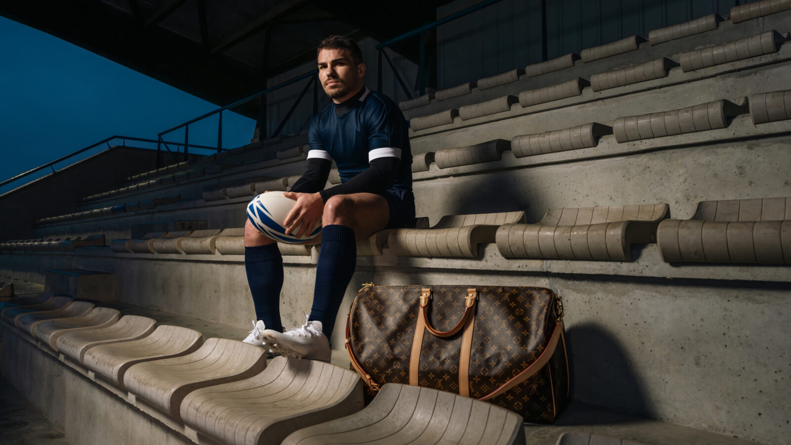 Set against the iconic backdrop of a rugby stadium, Antoine Dupont captures the essence of determination and refinement as Louis Vuitton's latest ambassador. (Photo Credit: Nelson Rosier)