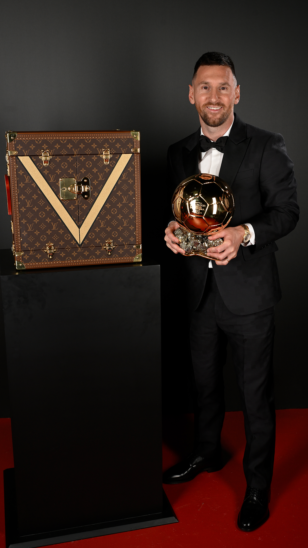 Lionel Messi with the prestigious award, juxtaposed by the iconic Louis Vuitton case. Lionel Messi with the prestigious award, juxtaposed by the iconic Louis Vuitton case.