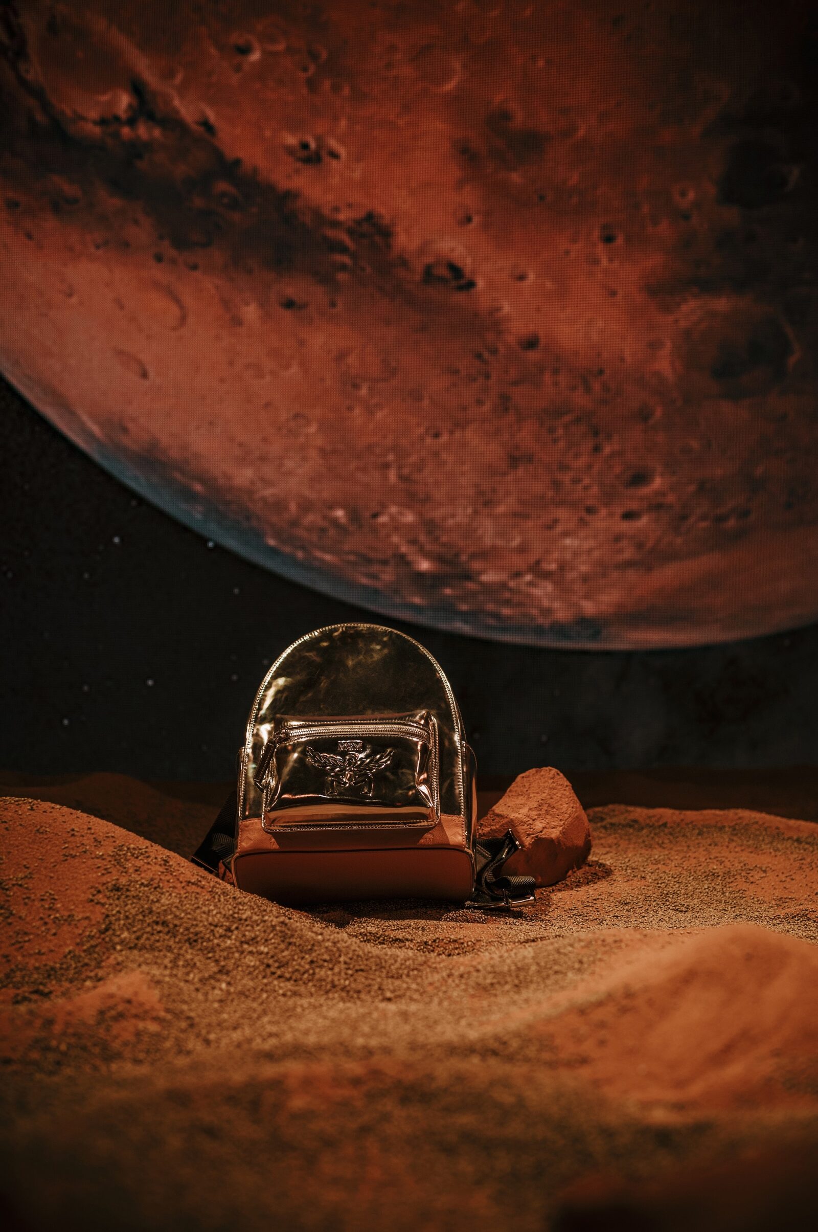 A Celestial Vision: The novel MCM bag shines against a Martian backdrop, symbolizing a bold leap into the future of fashion.