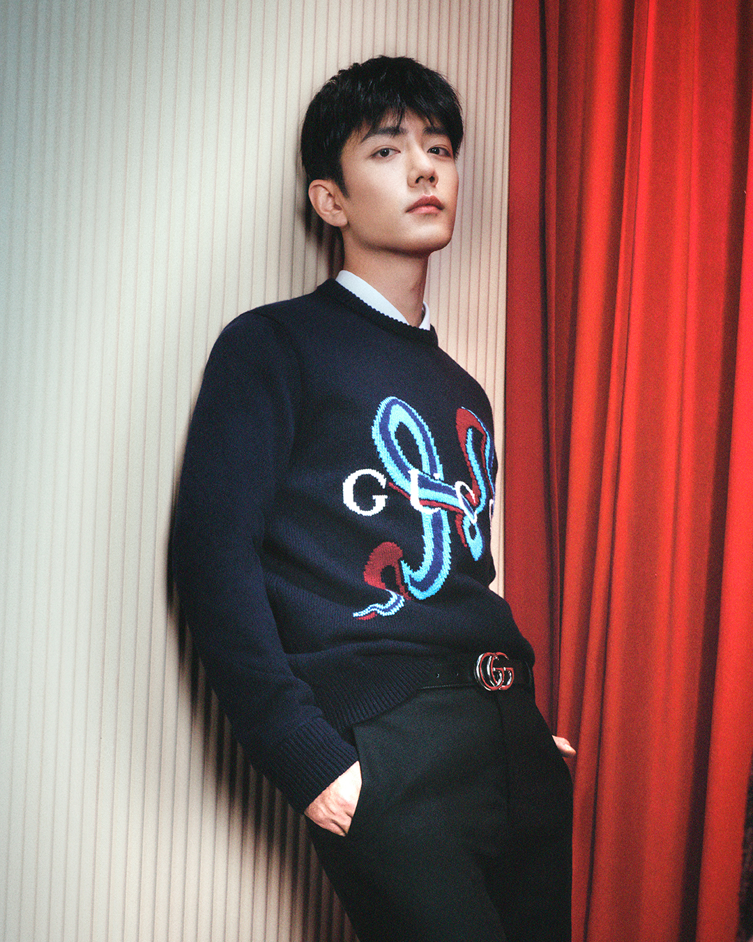 Xiao Zhan in a navy wool and cashmere jumper featuring a snake intarsia design, paired with a white dress shirt, grey trousers and the signature Marmont GG belt. (Image: Courtesy of Gucci)