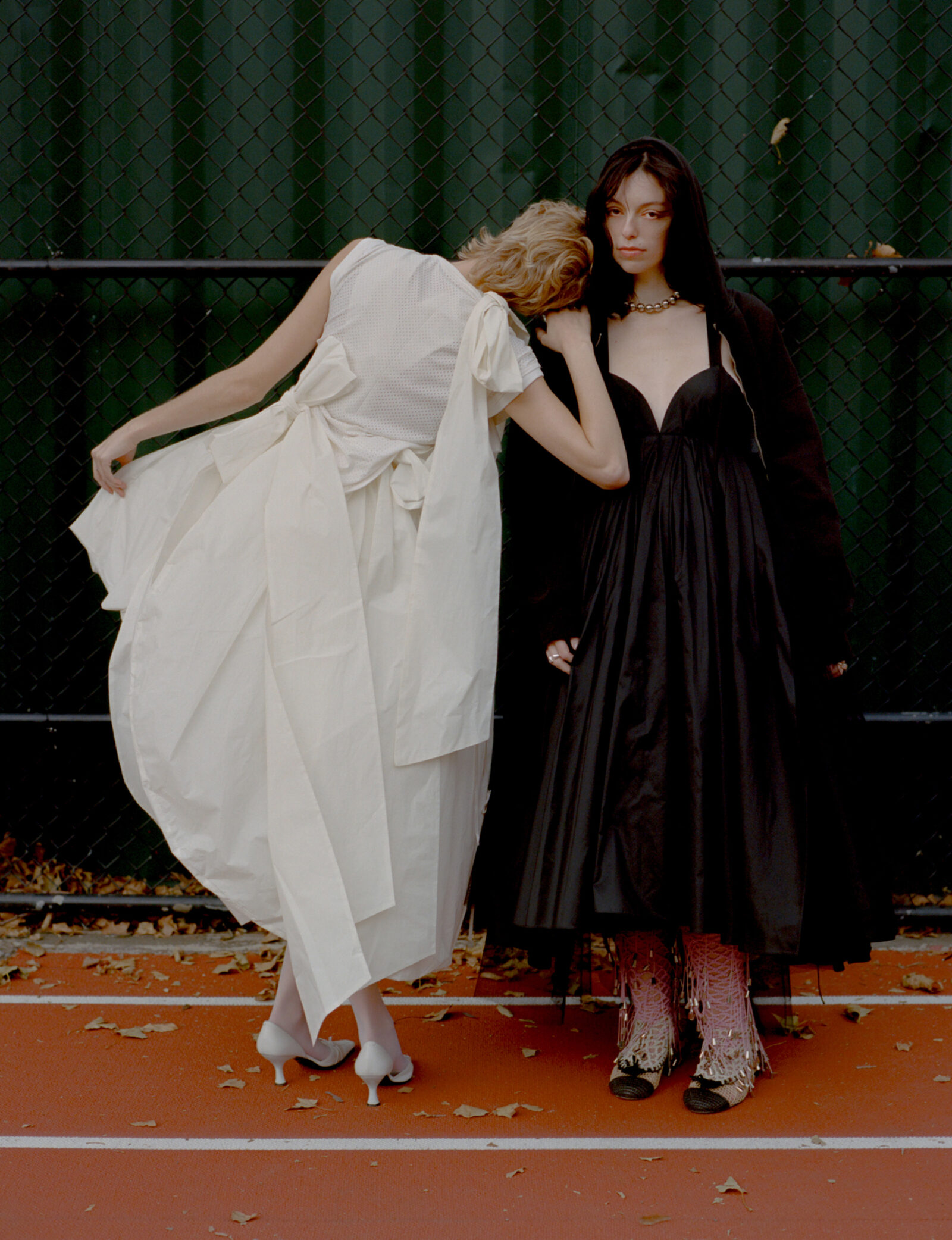 Left: Top by DENIZ BLUMENSTEIN, dress by MERUERT TOLEGAN, shoes, vintage, jewelry by WOLF CIRCUS. Right: Hoodie, stylist's own, dress by MERUERT TOLEGAN, shoes by GUI ROSA, necklace by HOPE AKIN, rings by WOLF CIRCUS.