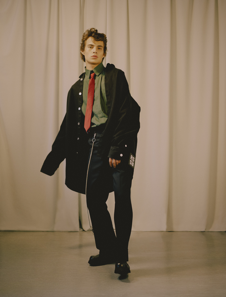 coat by RAF SIMONS, shirt by CRAIG GREEN, tie by LANVIN, chain by DELADA, shoes by UNDERGROUND louis baines fashion editorial