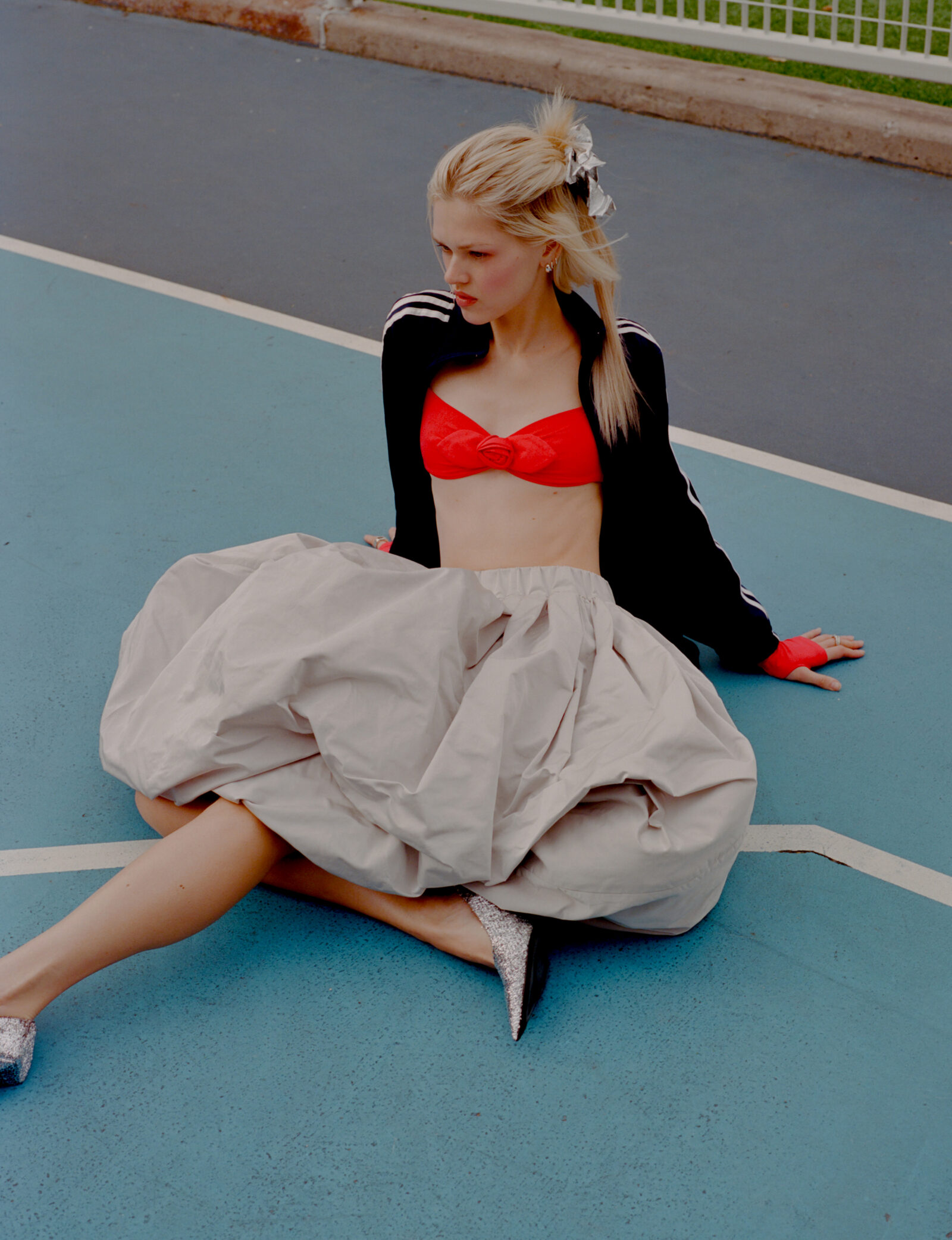 Bow by COMO SI FUERAN DIOSES, jacket, stylist's own, top by SANDY LIANG, skirt by DENIZ BLUMENSTEIN, shoes by BALENCIAGA, jewelry by WOLF CIRCUS.
