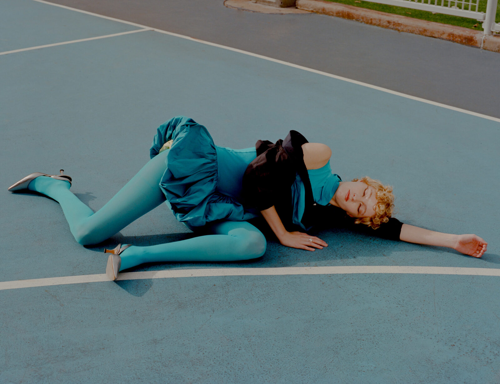 Dress and windbreaker by BRIAH ARTEMIS, tights by CALZEDONIA, shoes by MANOLO BLAHNIK, jewelry by WOLF CIRCUS.