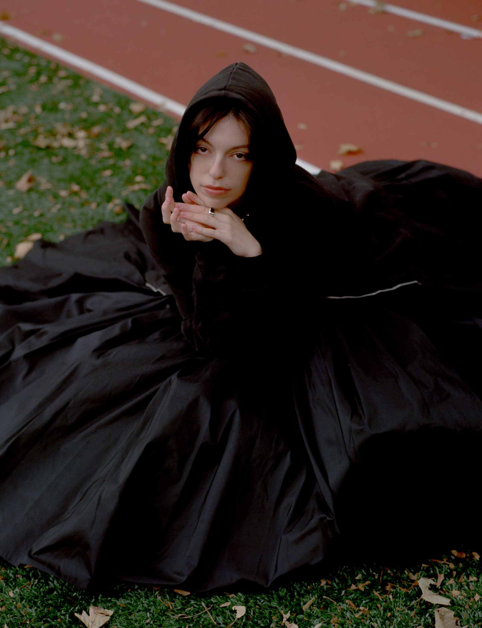Hoodie, stylist's own, dress by MERUERT TOLEGAN, shoes by GUI ROSA, necklace by HOPE AKIN, rings by WOLF CIRCUS