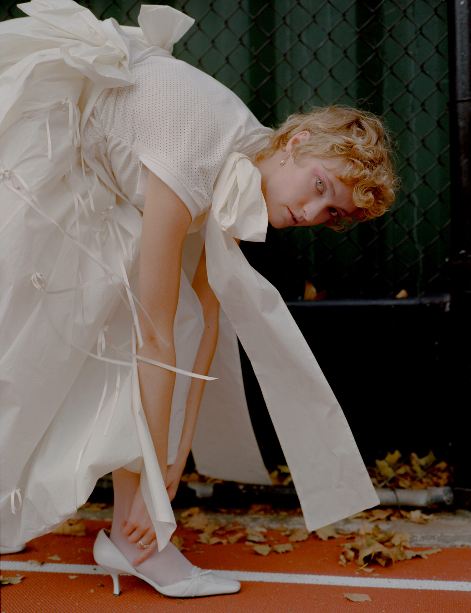 Top by DENIZ BLUMENSTEIN, dress by MERUERT TOLEGAN, shoes, vintage, jewelry by WOLF CIRCUS.