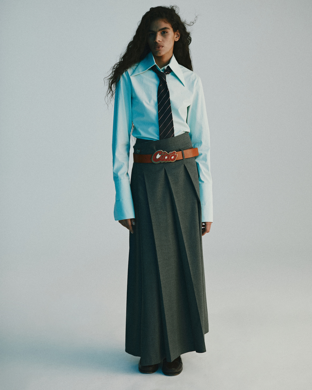 Shirt, skirt, belt by SPORTMAX, necktie by LOUIS VUITTON, shoes by SEBAGO Shirt, skirt, belt by SPORTMAX, necktie by LOUIS VUITTON, shoes by SEBAGO