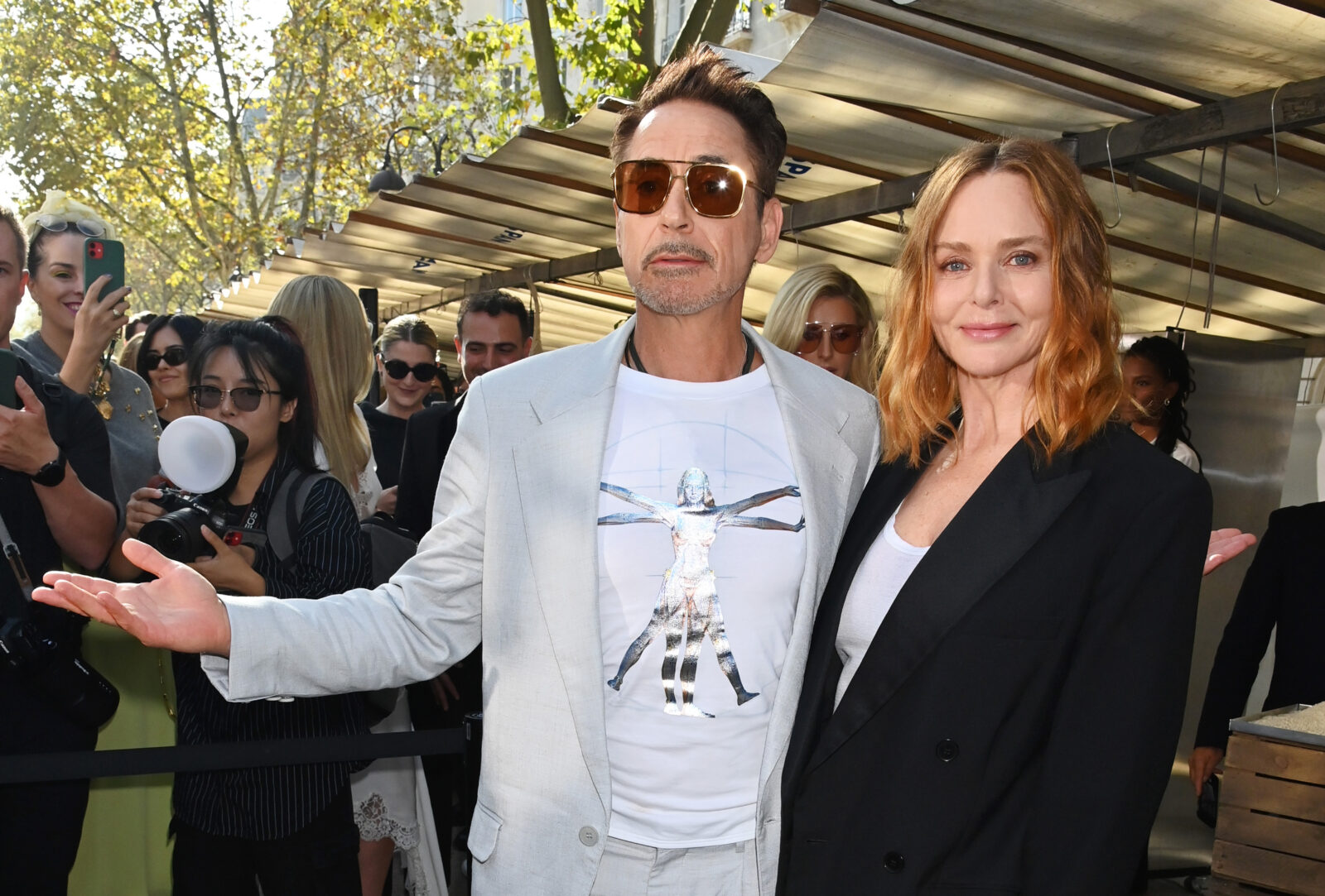 Stella McCartney, a beacon of sustainable luxury fashion, pictured with Robert Downey Jr. at the Paris Fashion Week showcasing her Spring/Summer 2024 collection. (Photo by Dave Benett)