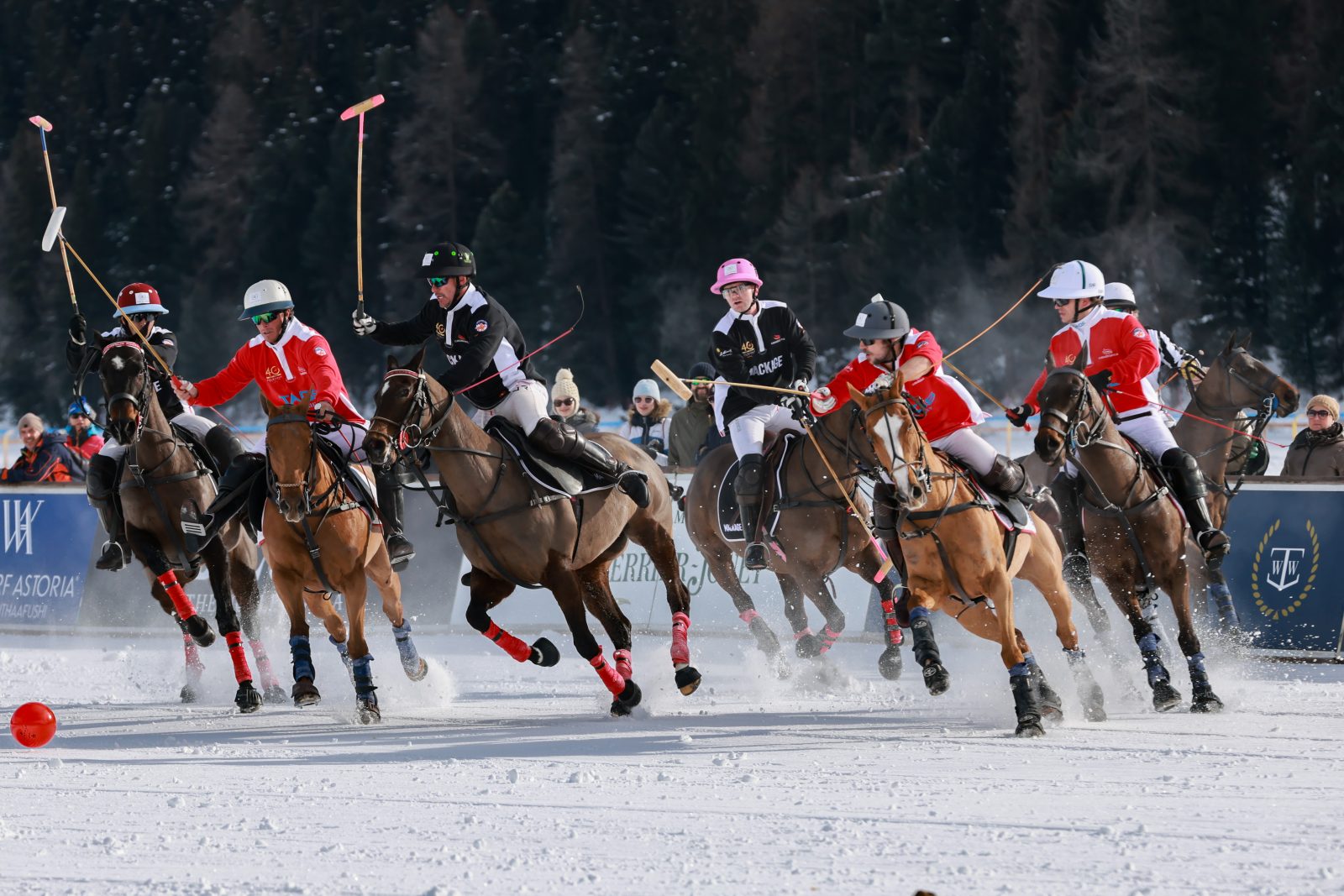 Dynamic action unfolds on the snow-covered grounds as Mackage's polo team, in signature noir-et-blanc technical uniforms, pursues victory at the milestone tournament. (Photo: St. Moritz Snow Polo World Cup) Dynamic action on the snow-covered grounds of St. Moritz as Mackage