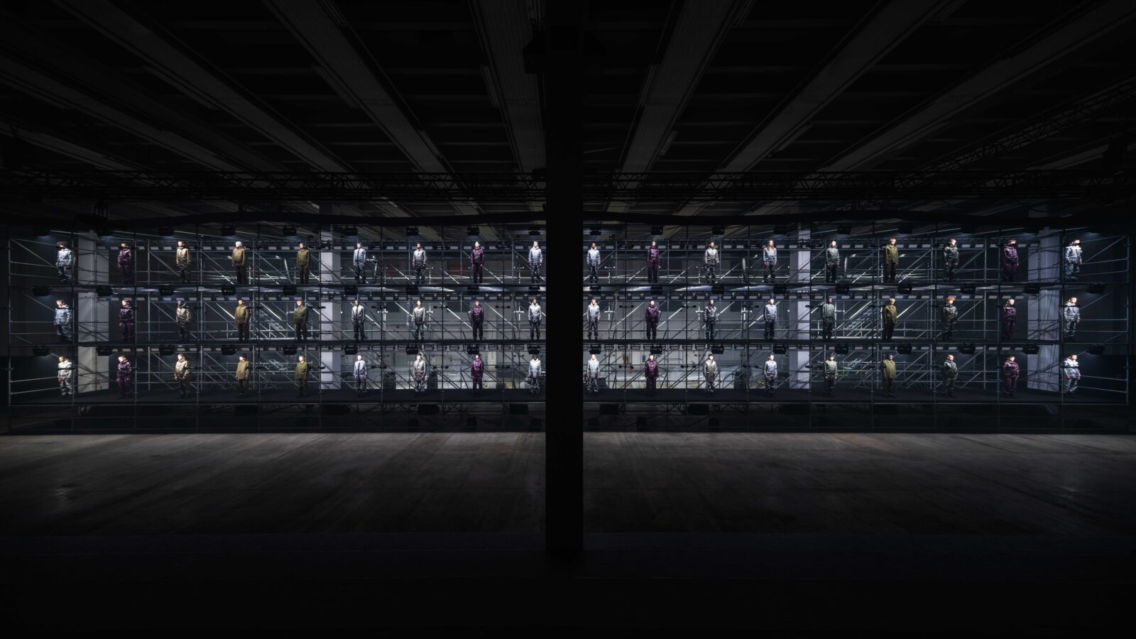 Stone Island's latest fashion installation showcases their 'The Compass Inside' manifesto, with models poised on an industrial scaffold, reflecting the brand's ethos of structure, innovation, and collective identity.
