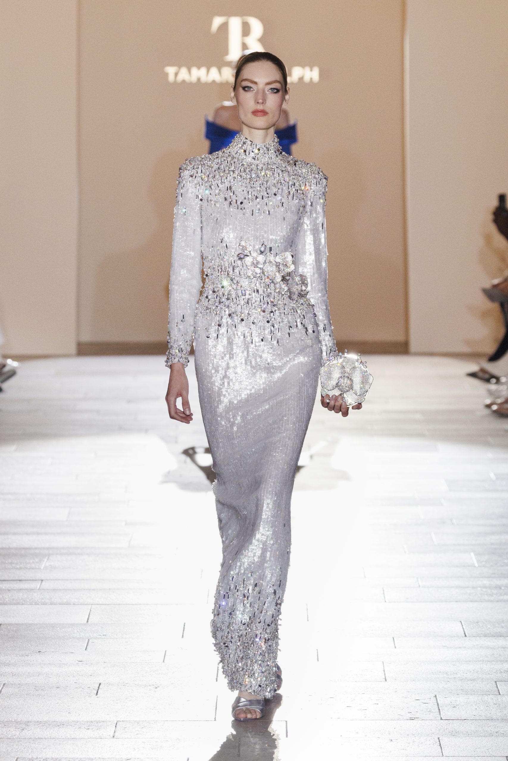 Look 10: Mother-of-pearl sequin gown with crystal embellishment, featuring a crystal orchid bouquet, accompanied by a crystal orchid clutch