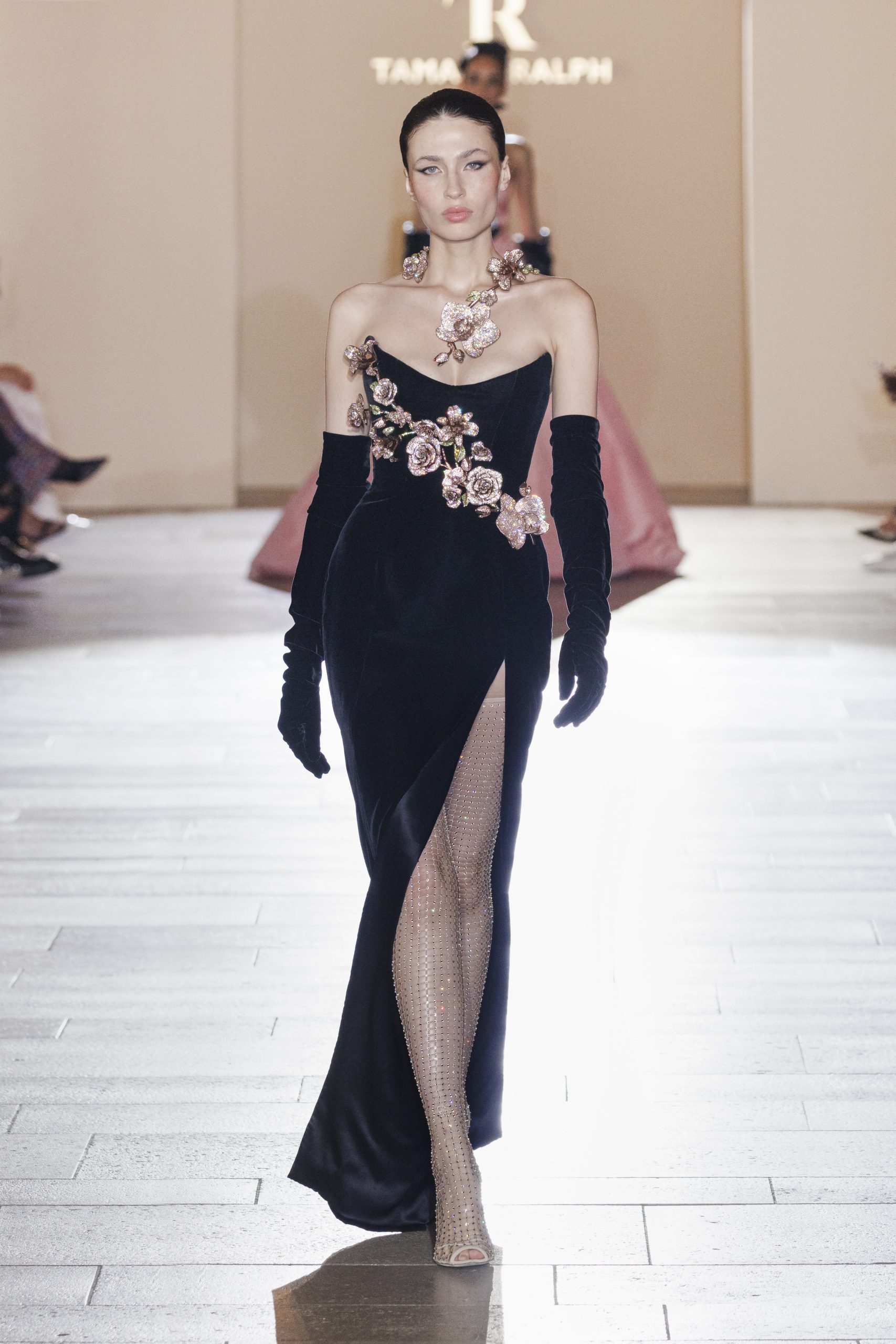 Look 22: Black silk velvet strapless gown featuring crystal orchid and lilies bouquet. Accompanied by ornate orchid crystal necklace, silk velvet opera gloves and crystal mesh boot