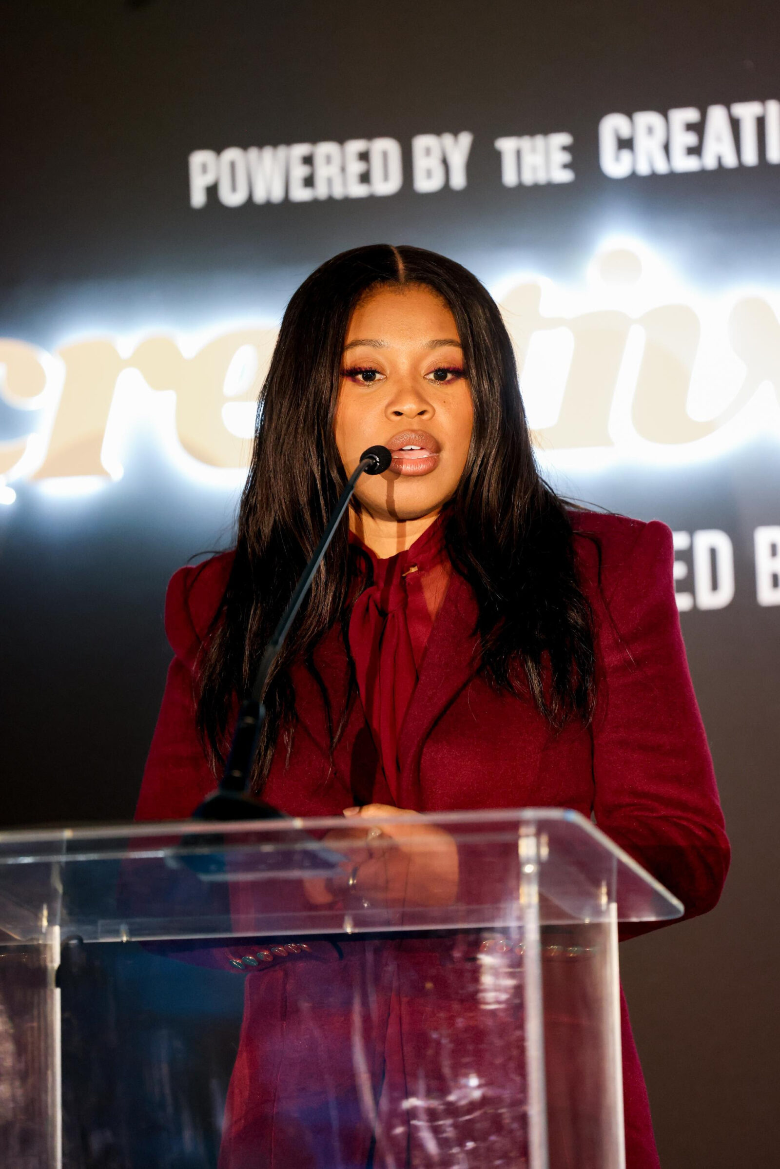 Dominique Fishback delivers a heartfelt speech at the Creative Collective NYC's Creative Class 2024 dinner, exuding confidence and grace in her Sergio Hudson suit. (Photo Credit: Kai Tsehay)