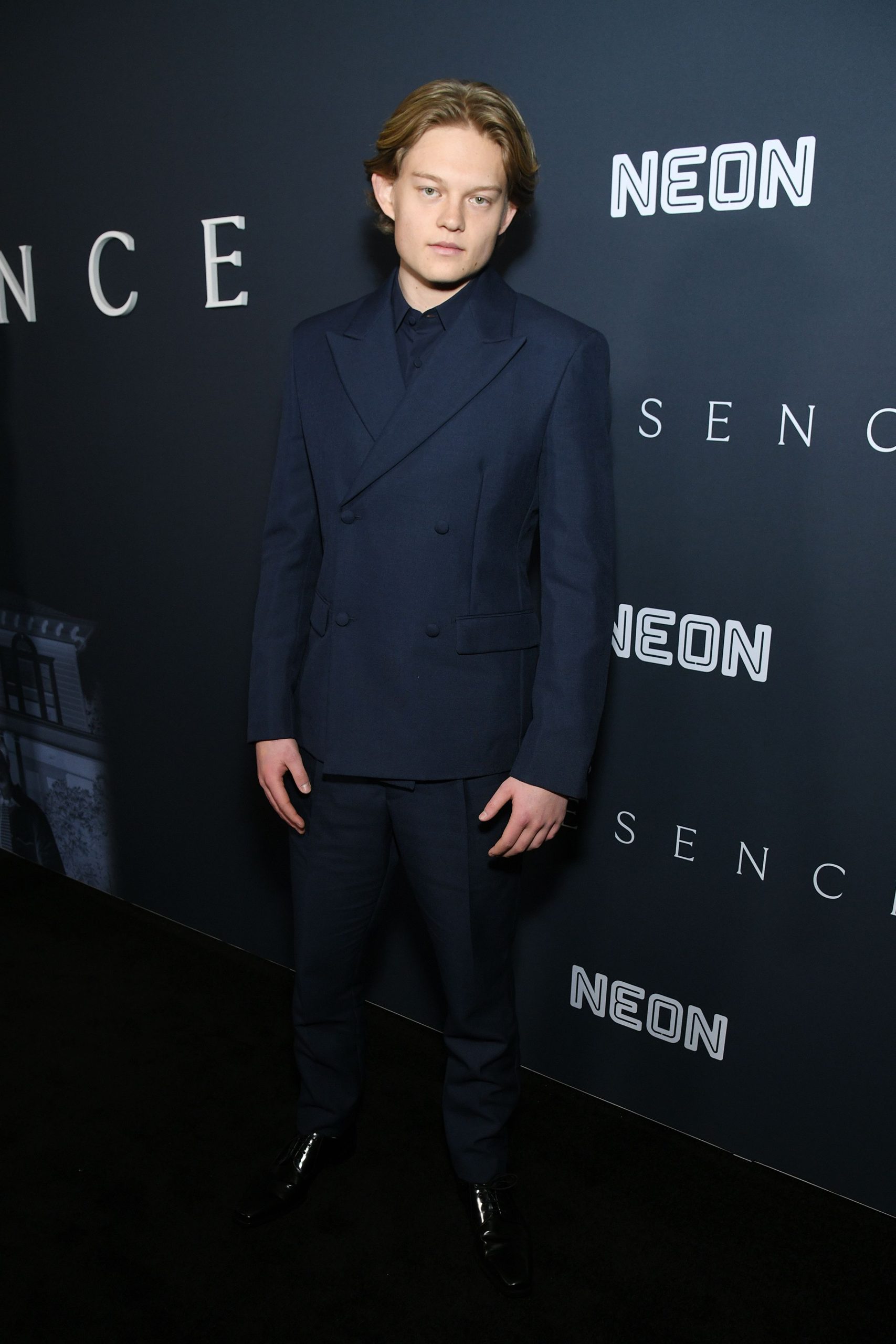 West Mulholland wears a sharp navy double-breasted suit by Prada with matching button-down shirt at the premiere of "Presence" held at Florence Gould Hall in New York City. (Photo: Kristina Bumphrey/Shutterstock)